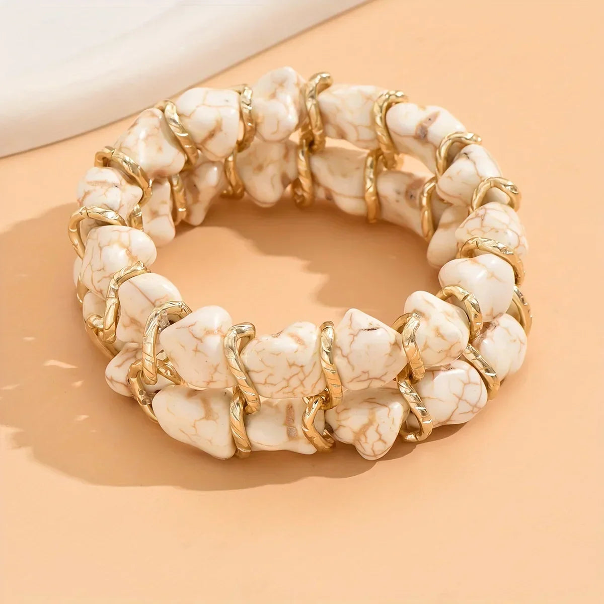 Bracciale intrecciato dorato con pietra turchese