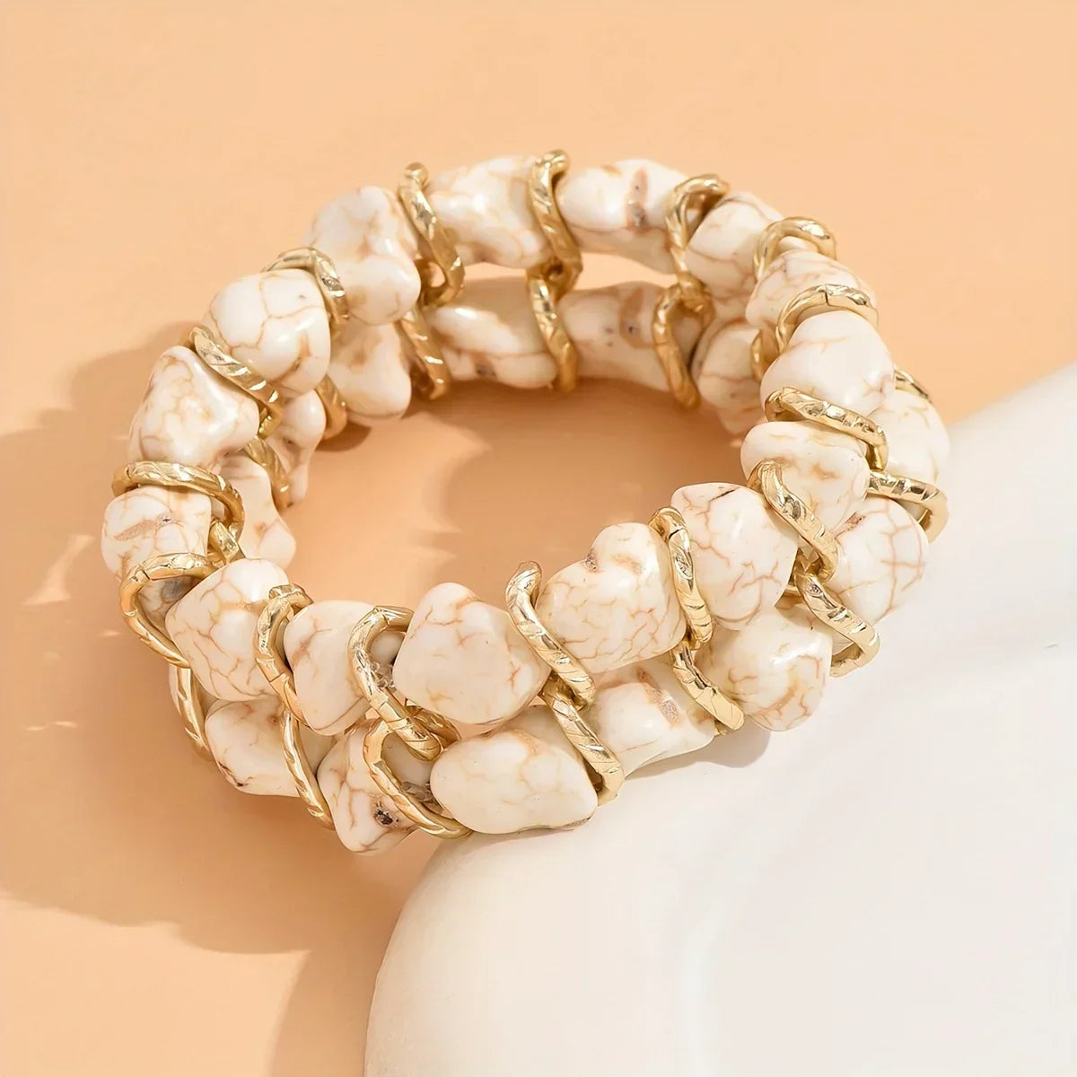 Bracciale intrecciato dorato con pietra turchese
