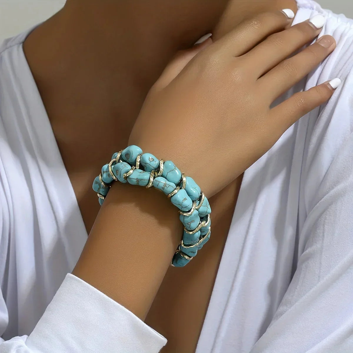 Bracciale intrecciato dorato con pietra turchese